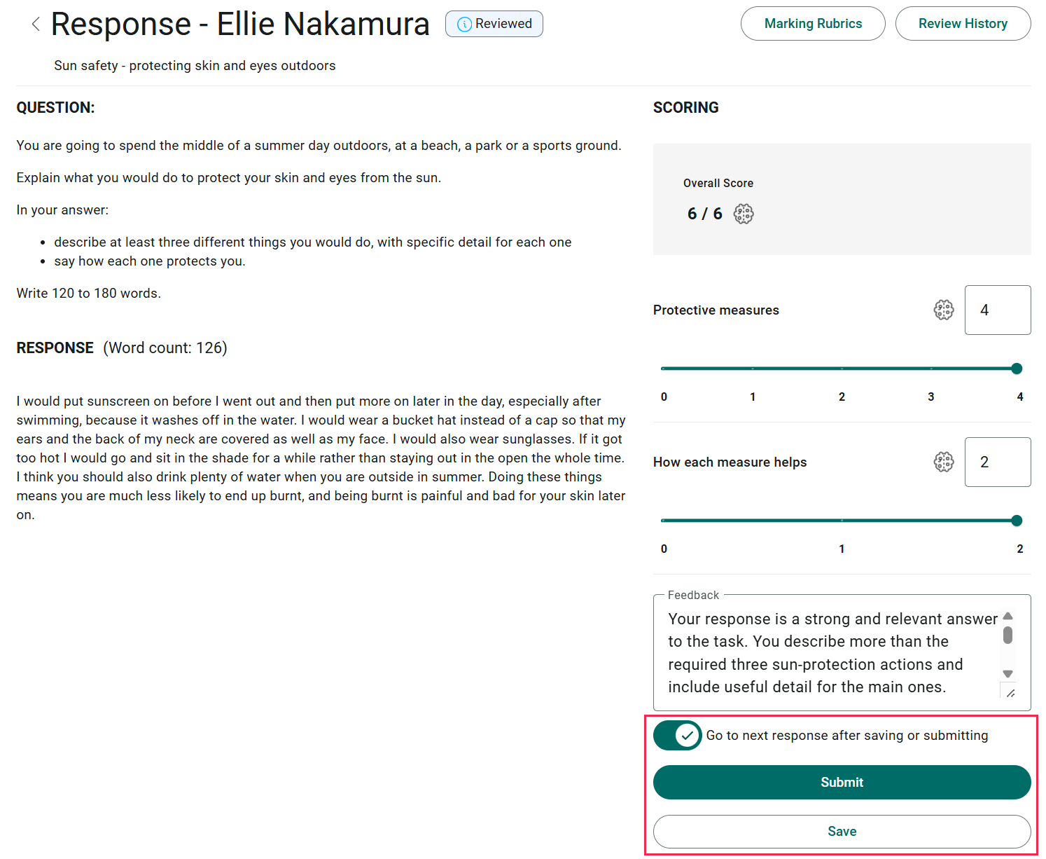 A reviewed response open for marking, with the Reviewed pill in the header, scores against both components, AI-written feedback, and the Go to next response toggle above the Submit and Save buttons